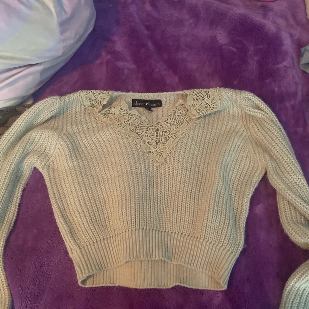 A cropped green knitted sweater